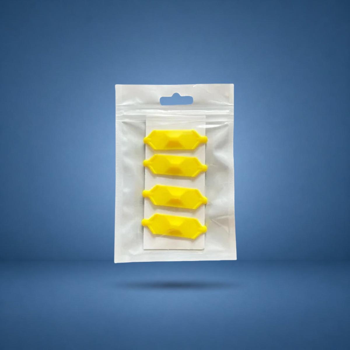 Anneaux de prise texturés jaunes, lot de 4 en sachet, visuel studio sur fond bleu terrain