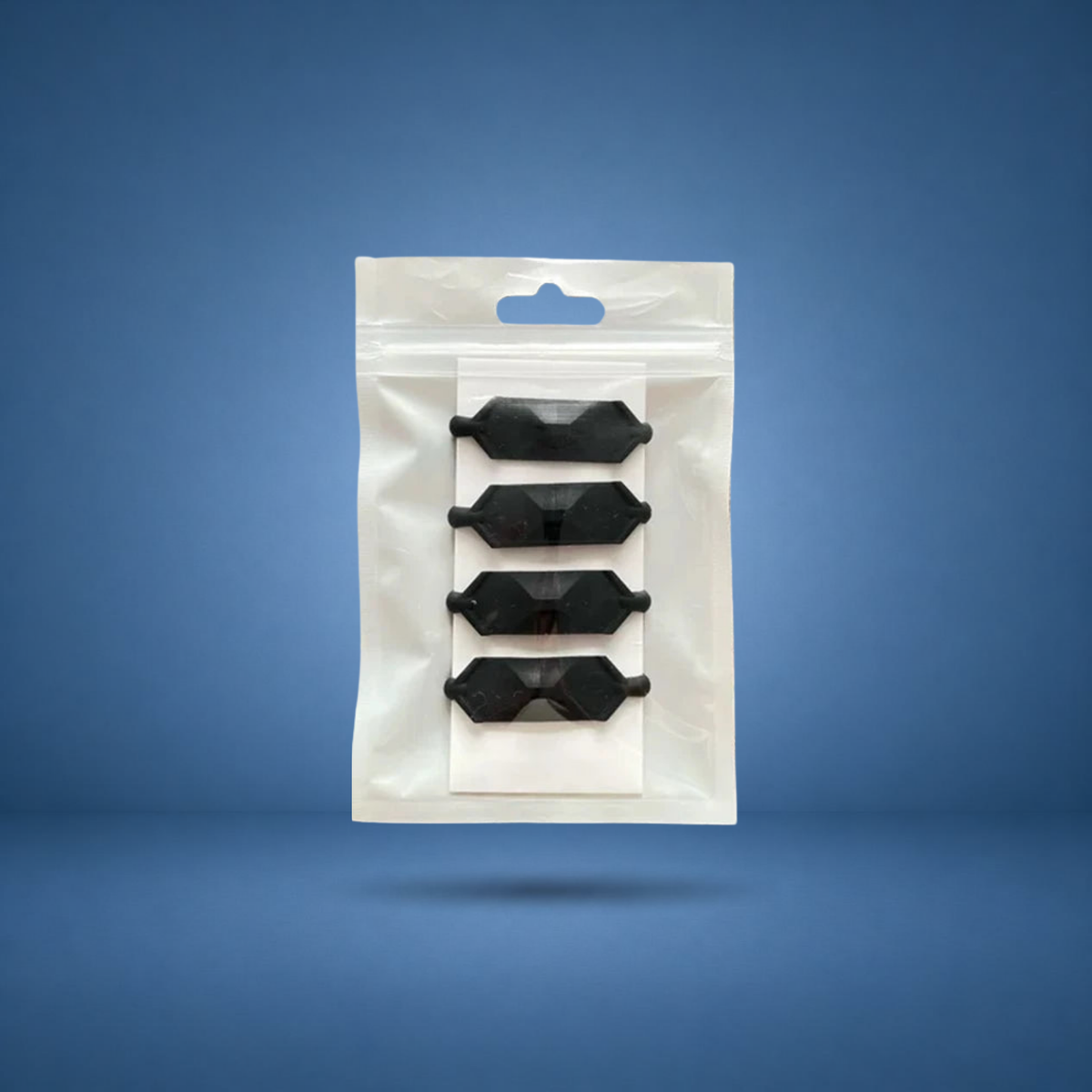 Anneaux de prise texturés noirs, lot de 4 en sachet, visuel studio sur fond bleu terrain