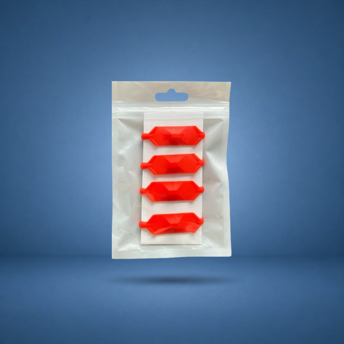 Anneaux de prise texturés rouges, lot de 4 en sachet, visuel studio sur fond bleu terrain