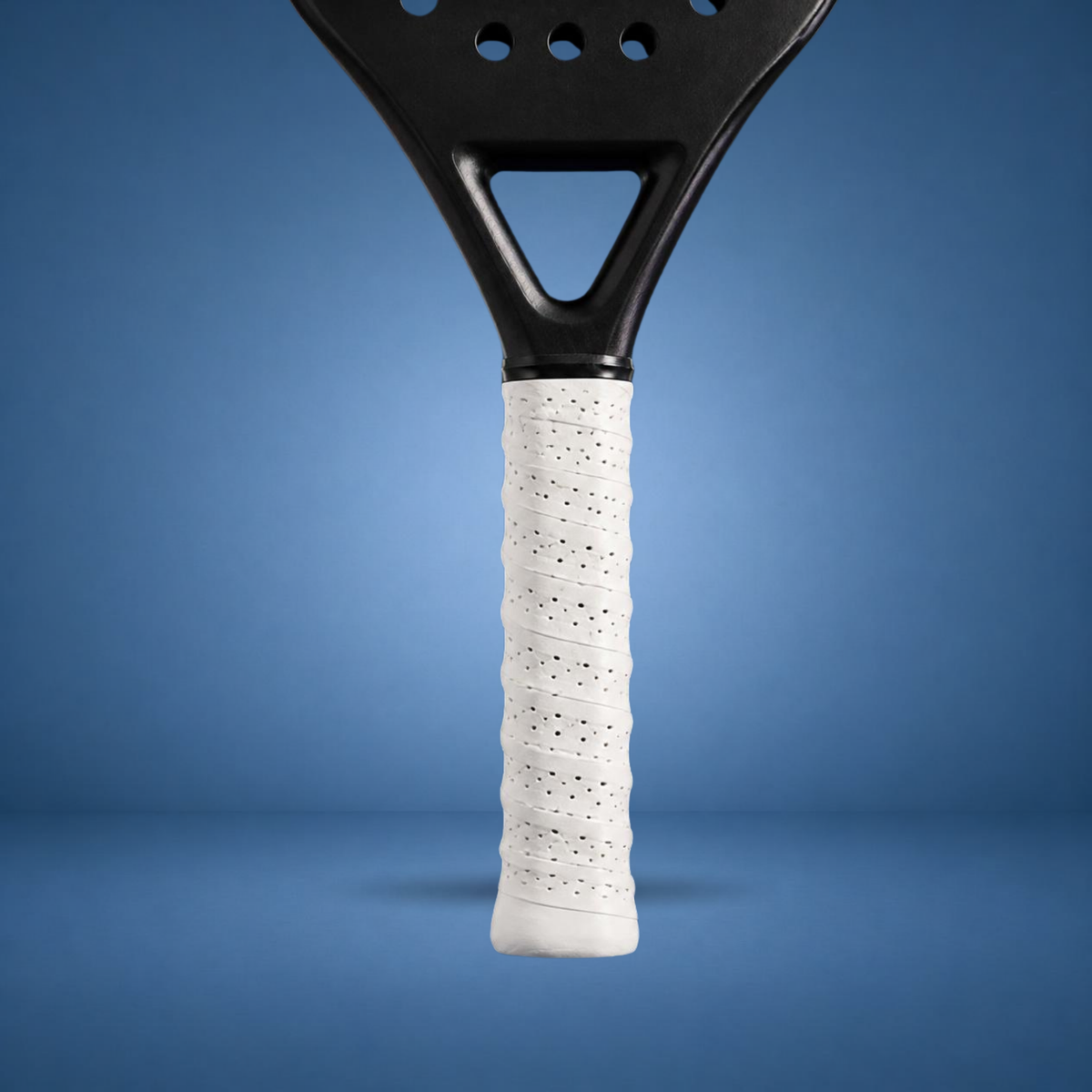 Surgrip perforé blanc sur un manche de raquette de padel, visuel studio sur fond bleu terrain (généré par IA)